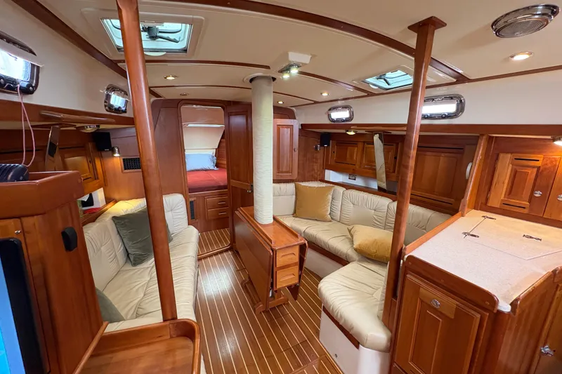 Slide: The Image of Luxurious 2007 Tartan 3700 CCR yacht interior with elegant wood finish and plush seating. - 21