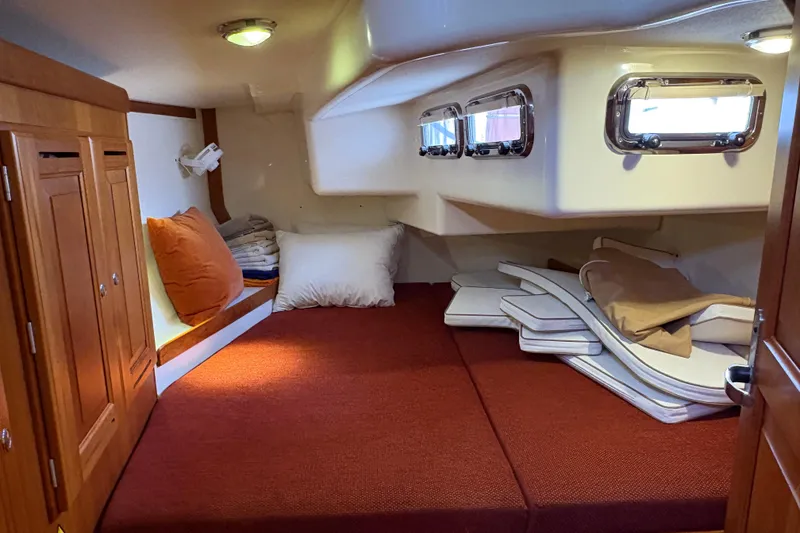Slide: The Image of Cozy cabin interior of 2007 Tartan 3700 CCR sailboat with cushions and wooden cabinetry. - 28