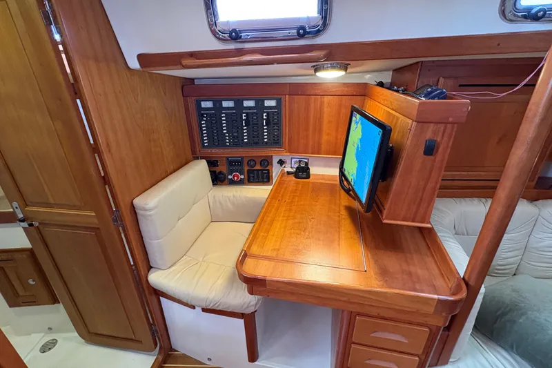Slide: The Image of Navigation station in 2007 Tartan 3700 CCR yacht with wood finish and control panel. - 35
