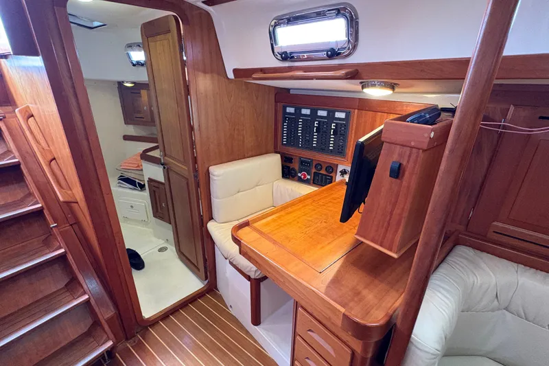 Slide: The Image of Interior of 2007 Tartan 3700 CCR sailboat with wood finish and navigation station. - 36