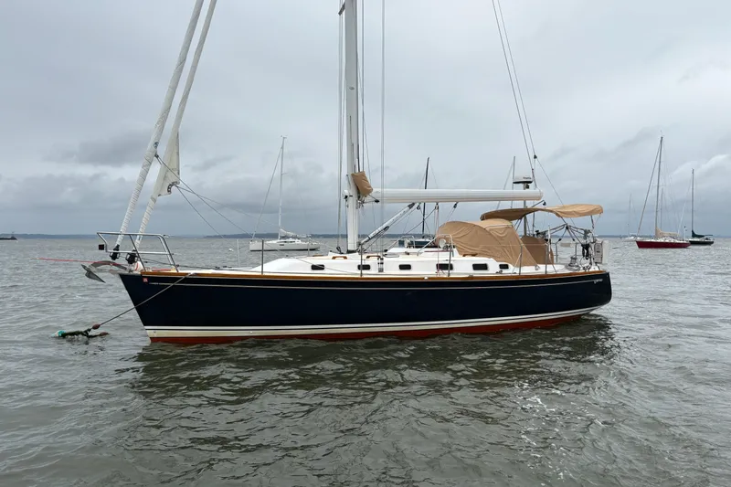Slide: The Image of 2007 Tartan 3700 CCR sailboat anchored on calm waters under cloudy skies. - 5