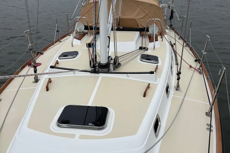 Slide: The Image of 2007 Tartan 3700 CCR sailboat deck with hatches and rigging, docked on calm water. - 8