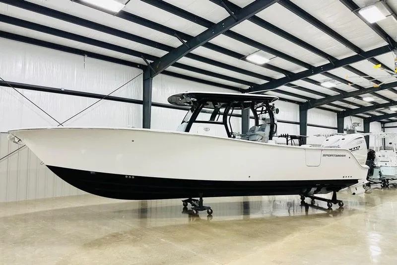 The Image of 2026 Sportsman Heritage 321 Center Console boat in a showroom, side view. - 1