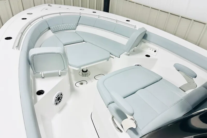 Slide: The Image of 2026 Sportsman Heritage 321 Center Console boat interior with light blue seating and modern design. - 10