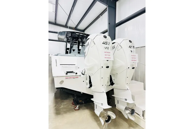Slide: The Image of 2026 Sportsman Heritage 321 Center Console with twin 450 V8 engines in a showroom. - 16