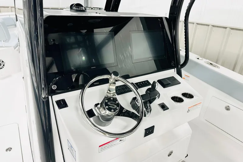 Slide: The Image of 2026 Sportsman Heritage 321 Center Console helm with modern controls and dual displays. - 2