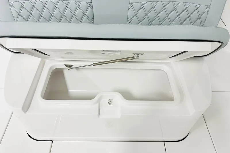 Slide: The Image of 2026 Sportsman Heritage 321 Center Console seat storage compartment, open with diamond-stitched upholstery. - 7