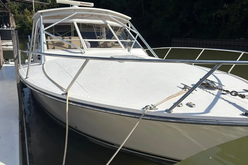 Slide: The Image of 2006 Carolina Classic 32 boat docked, featuring sleek design and sturdy build. - 0