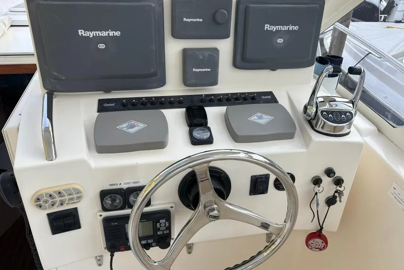 Slide: The Image of Helm of 2006 Carolina Classic 32 with Raymarine electronics and steering wheel. - 11