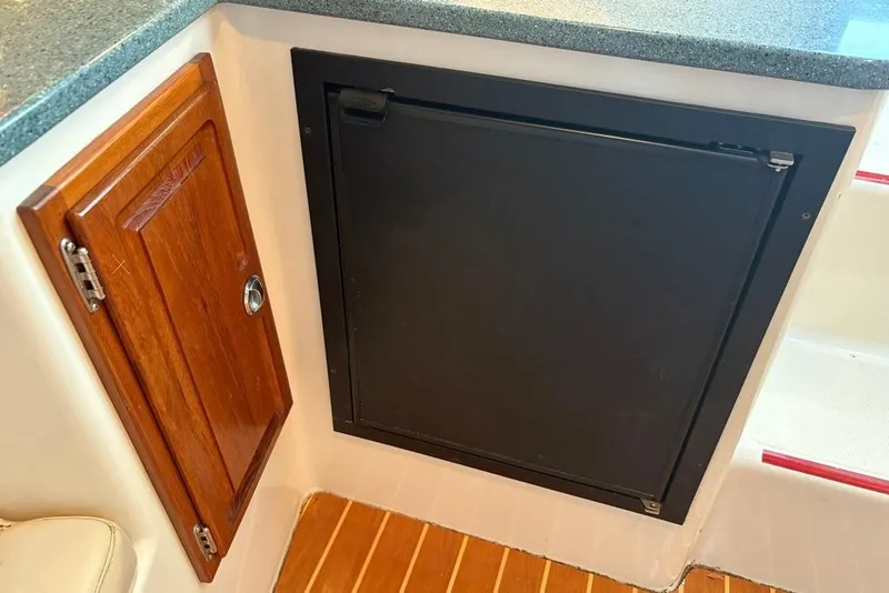 Slide: The Image of 2006 Carolina Classic 32 interior with wooden cabinet and black panel. - 16