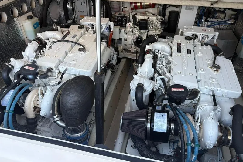 Slide: The Image of Engine room of a 2006 Carolina Classic 32 boat, featuring twin diesel engines. - 19
