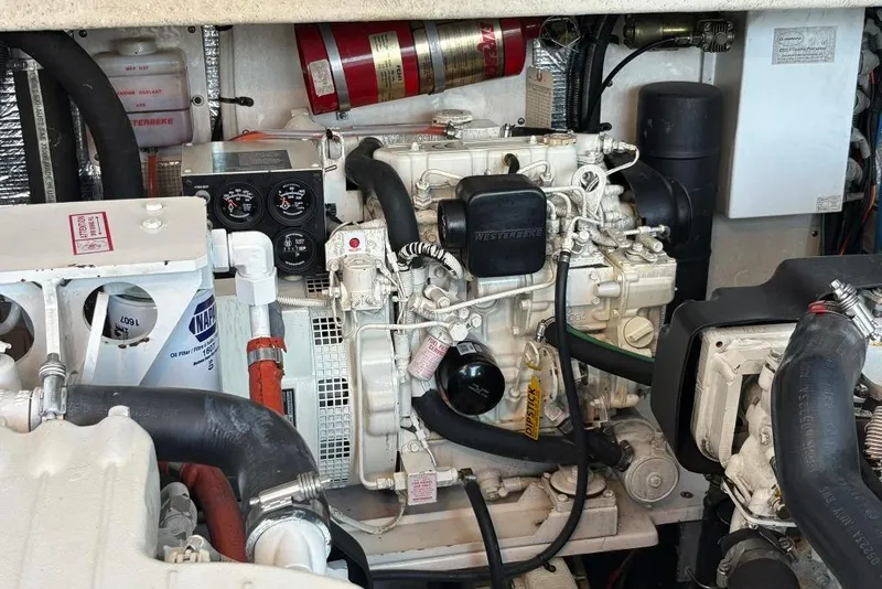 Slide: The Image of Engine room of a 2006 Carolina Classic 32 boat, featuring mechanical components. - 25