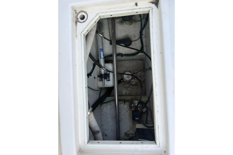 Slide: The Image of 2006 Carolina Classic 32 boat compartment with visible wiring and components. - 26