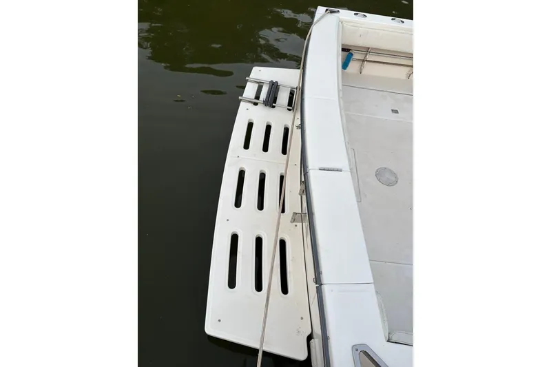 Slide: The Image of 2006 Carolina Classic 32 boat with swim platform on calm water. - 27