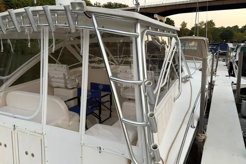Slide: The Image of 2006 Carolina Classic 32 boat docked, featuring white seating and aluminum frame. - 30