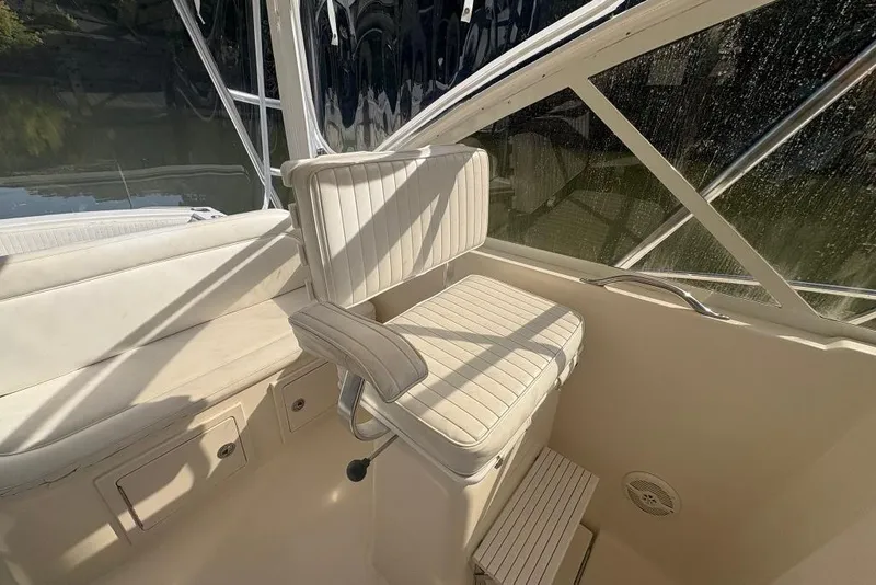 Slide: The Image of 2006 Carolina Classic 32 boat interior with white seating and window view. - 32