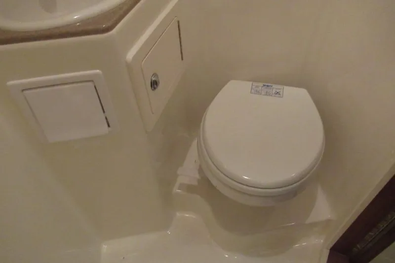 Slide: The Image of Compact marine toilet in 2006 Carolina Classic 32 boat bathroom. - 34