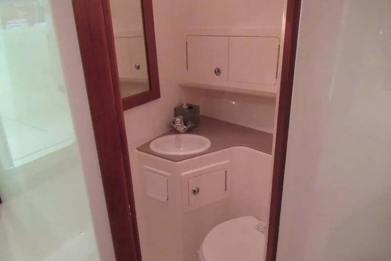 Slide: The Image of Bathroom interior of 2006 Carolina Classic 32 boat, featuring sink and storage cabinets. - 35