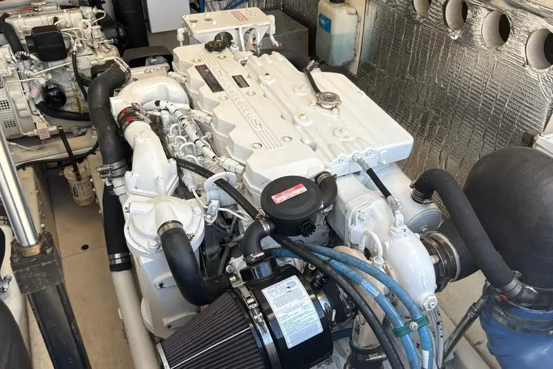 Slide: The Image of Engine room of a 2006 Carolina Classic 32 boat, featuring dual engines and mechanical components. - 38