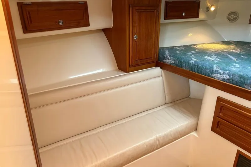 Slide: The Image of 2006 Carolina Classic 32 cabin interior with wooden cabinets and cushioned seating. - 6