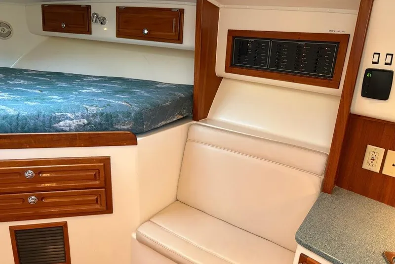 Slide: The Image of Interior of a 2006 Carolina Classic 32 boat with bed and control panel. - 7