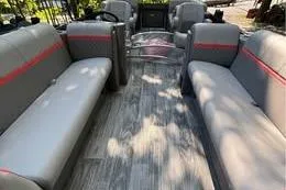 Slide: The Image of 2023 Qwest RLS 822 pontoon boat interior with gray seating and red accents. - 5