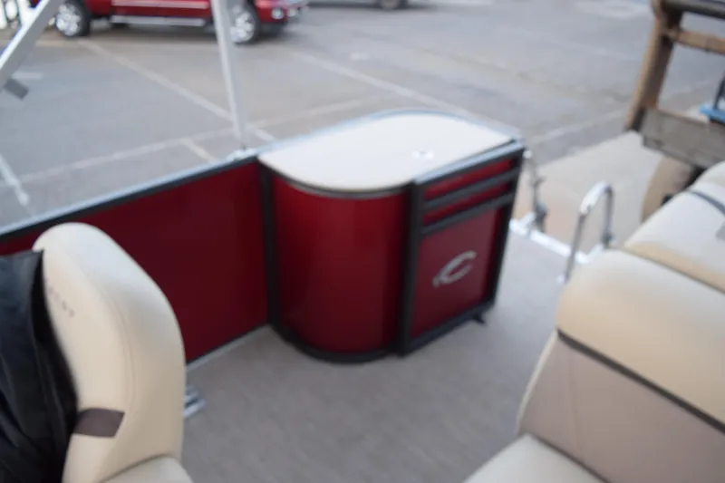 Slide: The Image of 2024 Crest Classic LX 200 L interior with red paneling and beige seating. - 12