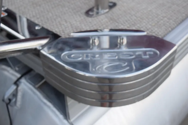Slide: The Image of 2024 Crest Classic LX 200 L boat step with logo, featuring sleek metallic design. - 16