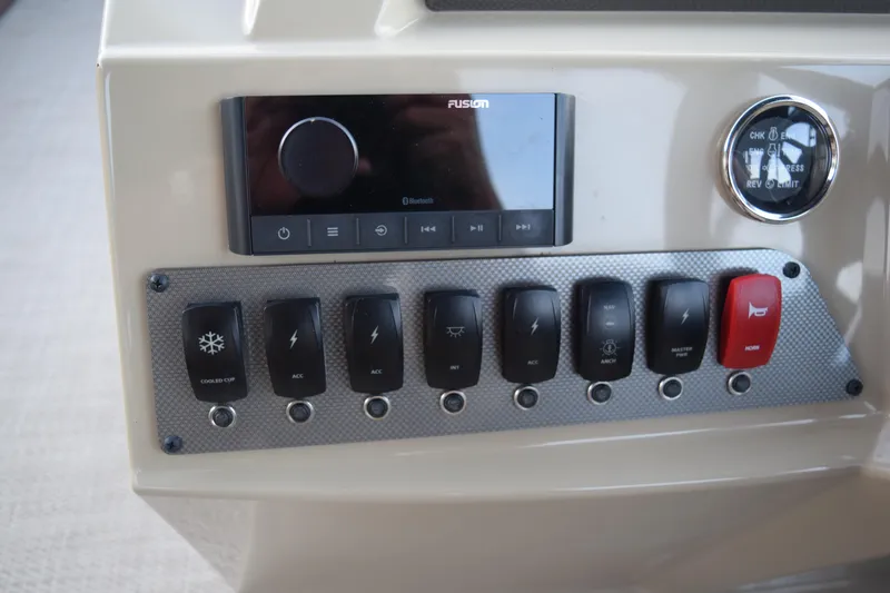 Slide: The Image of Control panel of 2024 Crest Classic LX 200 L boat with switches and audio system. - 9