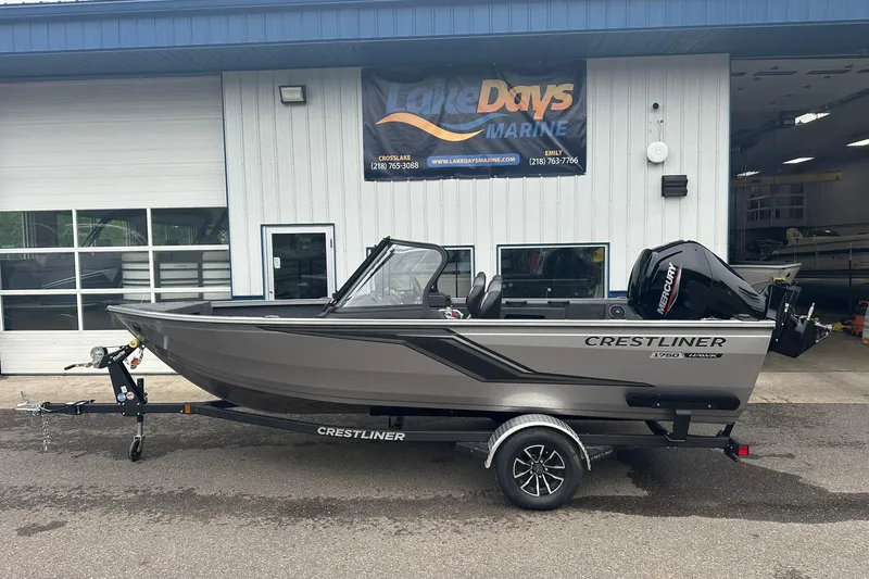The Image of 2025 Crestliner 1750 Hawk boat on trailer outside Lake Days Marine shop. - 1
