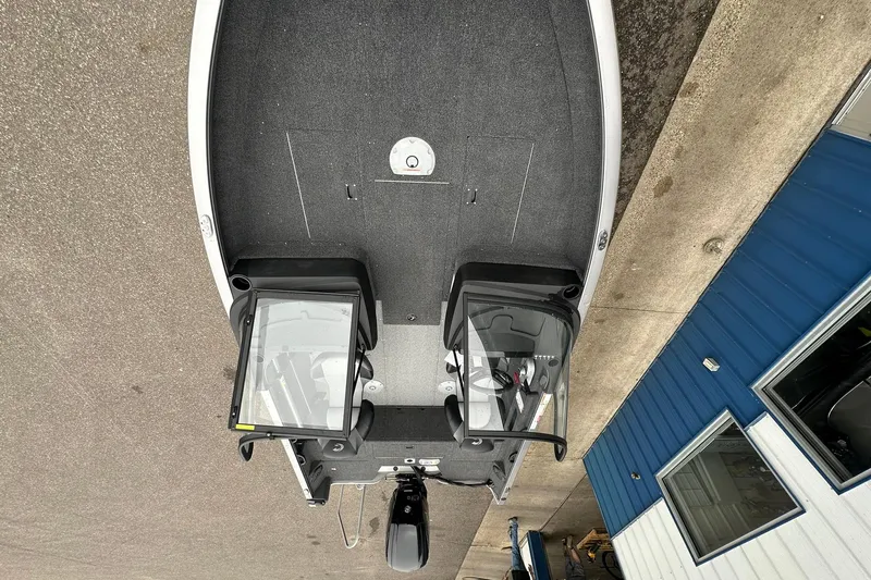 Slide: The Image of 2025 Crestliner 1750 Hawk boat, aerial view, parked near blue building. - 13