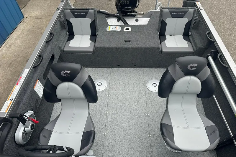 Slide: The Image of 2025 Crestliner 1750 Hawk boat interior with four seats and steering console. - 14