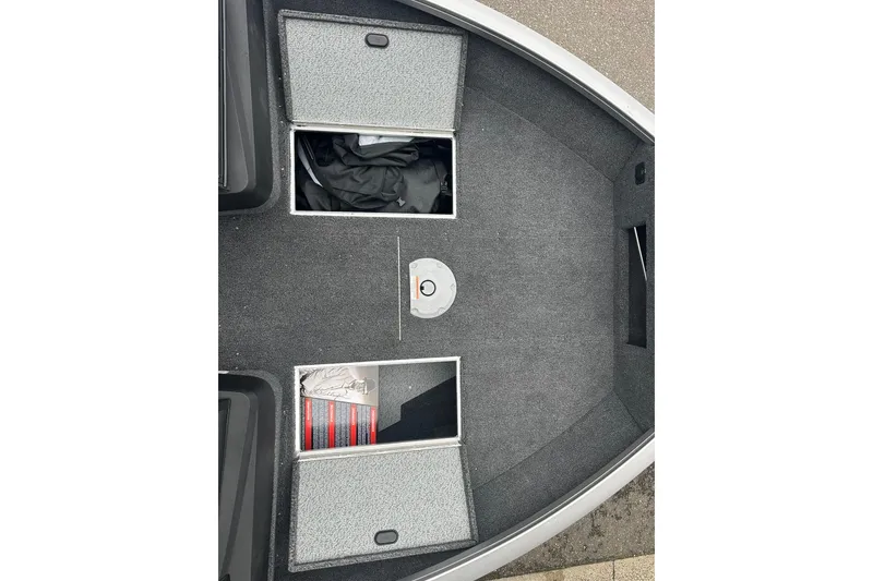 Slide: The Image of 2025 Crestliner 1750 Hawk boat interior with open storage compartments. - 17