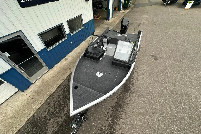 Slide: The Image of 2025 Crestliner 1750 Hawk boat parked outside a building, top view. - 7