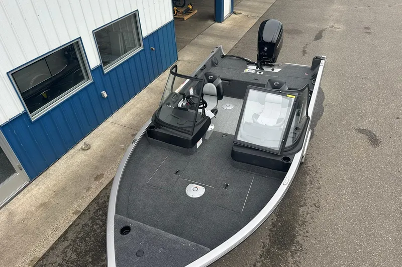 Slide: The Image of 2025 Crestliner 1750 Hawk boat parked outside a building, showcasing its sleek design. - 8