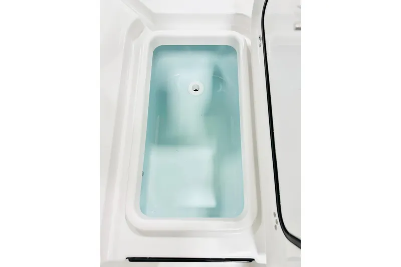 Slide: The Image of Livewell compartment in 2026 Sportsman Masters 227 Bay Boat, filled with water. - 13