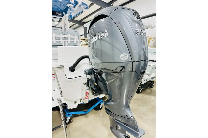 Slide: The Image of 2026 Sportsman Masters 227 Bay Boat with powerful outboard motor in showroom. - 15