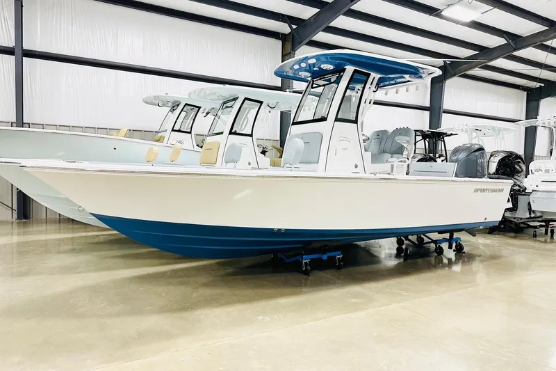 The Image of 2026 Sportsman Masters 227 Bay Boat in showroom, featuring sleek design and modern amenities. - 2