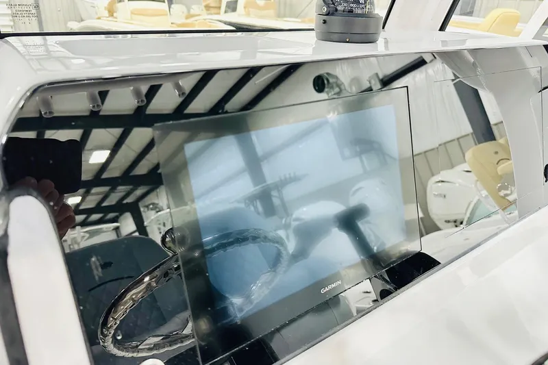 Slide: The Image of 2026 Sportsman Masters 227 Bay Boat dashboard with Garmin display and compass. - 4