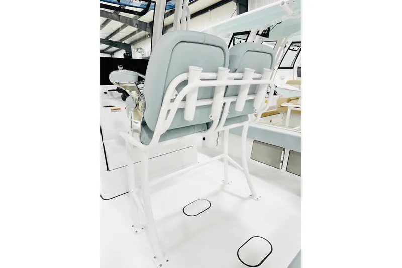 Slide: The Image of 2026 Sportsman Masters 227 Bay Boat interior with dual seats and rod holders. - 6