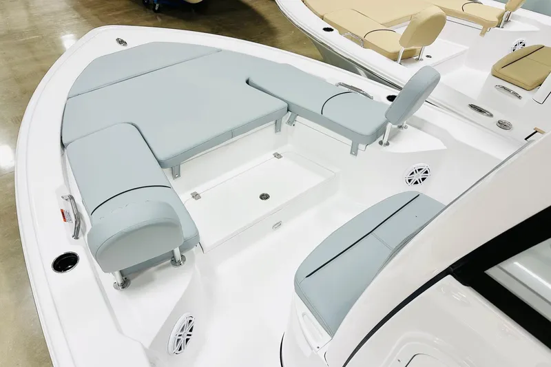 Slide: The Image of 2026 Sportsman Masters 227 Bay Boat interior with gray seating and storage compartments. - 8