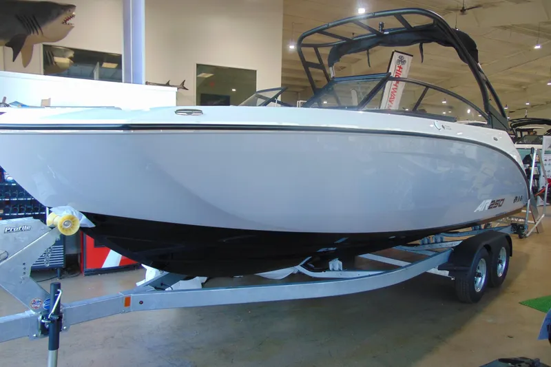 Slide: The Image of 2026 Yamaha Boats AR250 on trailer in showroom, sleek design, modern features. - 12