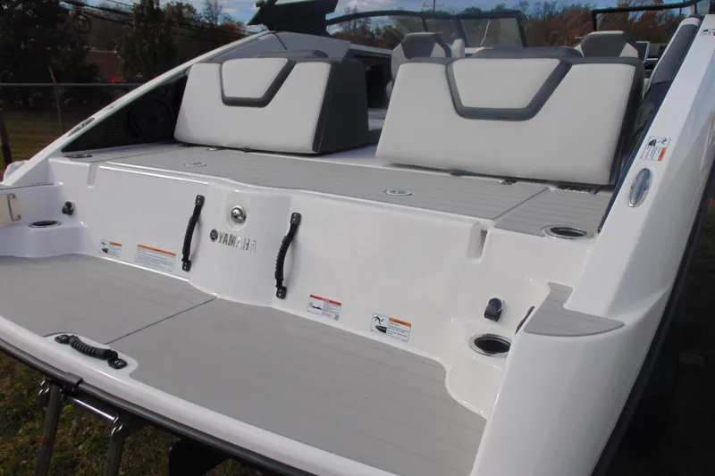 Slide: The Image of 2026 Yamaha Boats AR250 rear deck with seating and cup holders. - 14