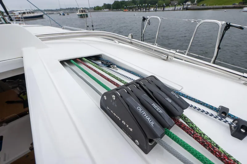 Slide: The Image of 2026 J Boats J/40 sailboat deck with colorful ropes and cleats by the water. - 11