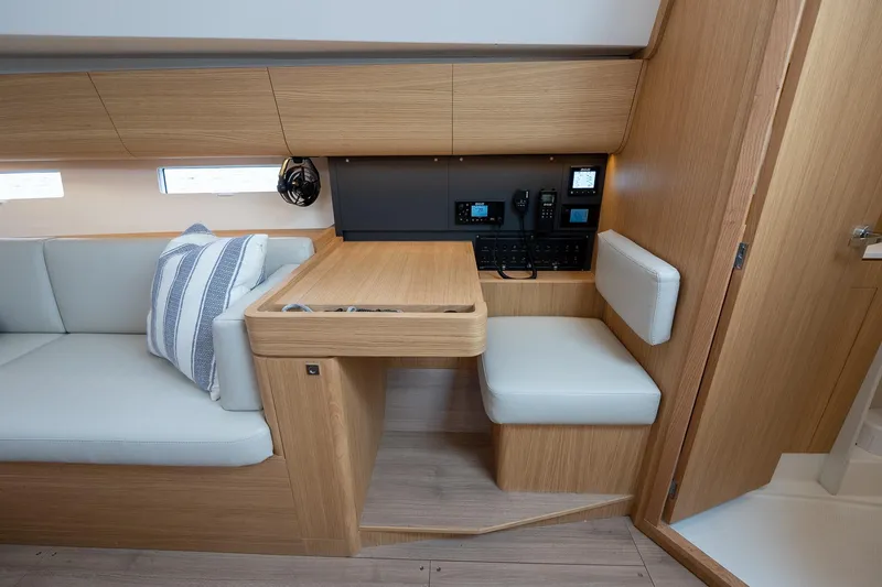 Slide: The Image of 2026 J Boats J/40 interior with navigation station, wood finish, and cushioned seating. - 30