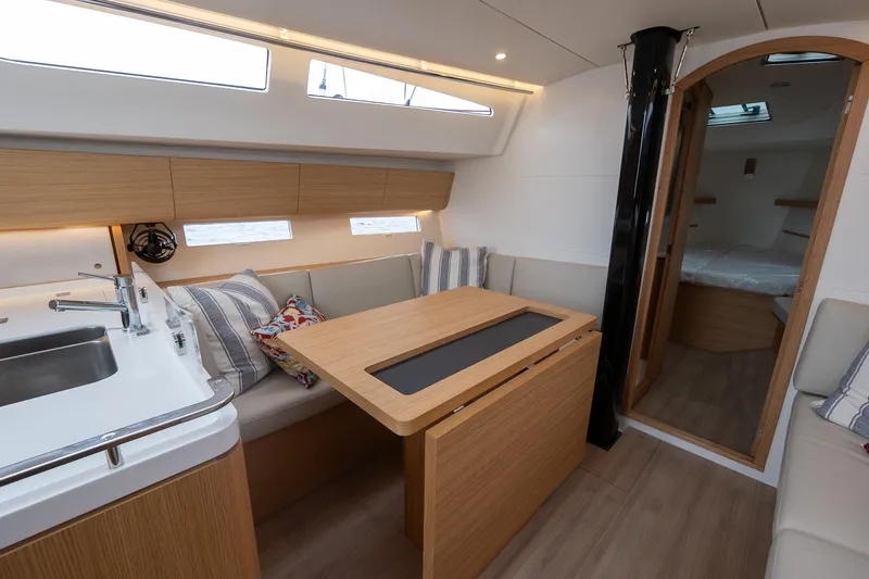 Slide: The Image of Modern interior of 2026 J Boats J/40 sailboat, featuring a cozy dining area and kitchenette. - 39