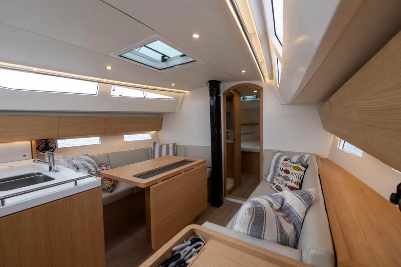 Slide: The Image of 2026 J Boats J/40 interior with modern wood finish, cozy seating, and ample natural light. - 40