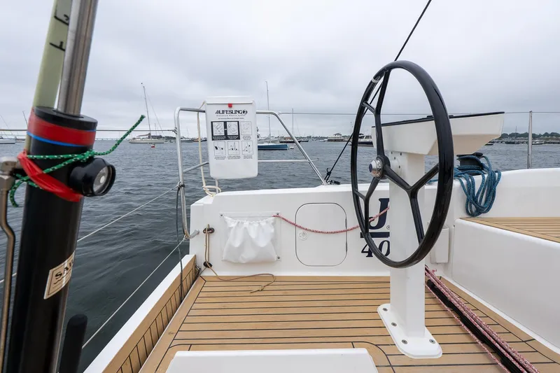 Slide: The Image of 2026 J Boats J/40 sailboat cockpit with steering wheel, lifebuoy, and teak decking. - 8