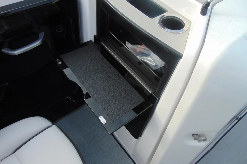 Slide: The Image of 2026 Yamaha AR250 boat interior with storage compartment and cup holder. - 12