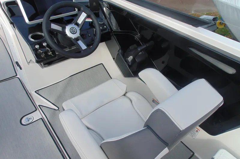 Slide: The Image of 2026 Yamaha Boats AR250 cockpit with steering wheel and comfortable seating. - 14